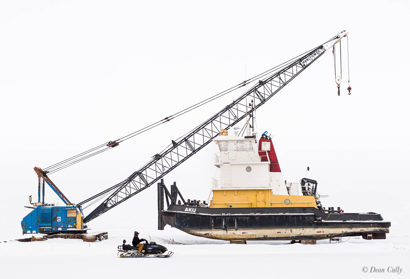 Kotzebue Still-Life with Snowmachine: crane, snowmobile and tugboat in whiteout repose;  northwestern Alaska